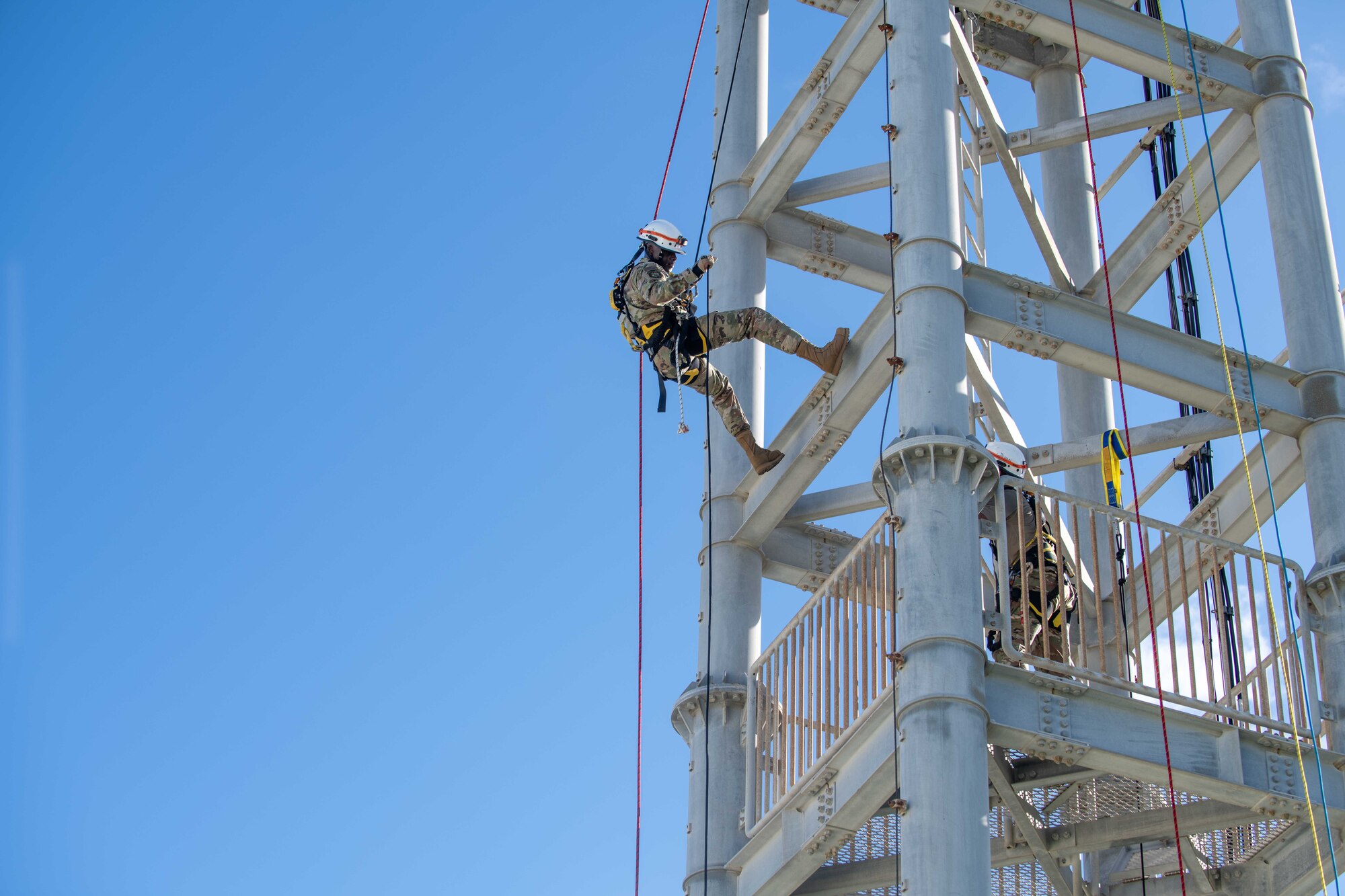military member rappels down a training tower