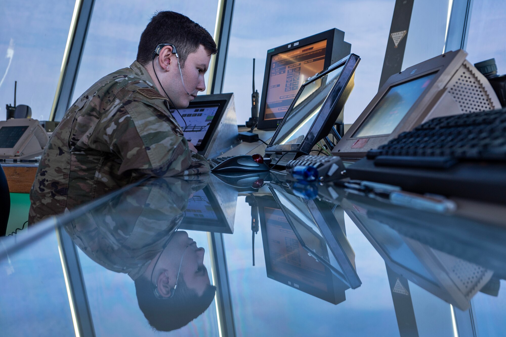 Senior Airman Andrew Huynh, an air traffic control specialist assigned to the 92nd Operations Support Squadron, monitors the flight line at Fairchild Air Force Base, Washington, July 29, 2024. Huynh oversaw local control, communicating with aircraft to clear them for takeoff or landing. ATC specialists manage the flow of aircraft through all aspects of the flight, ensuring the safety and efficiency of air traffic on the ground and in the air. (U.S. Air Force photo by Senior Airman Morgan St Marks)