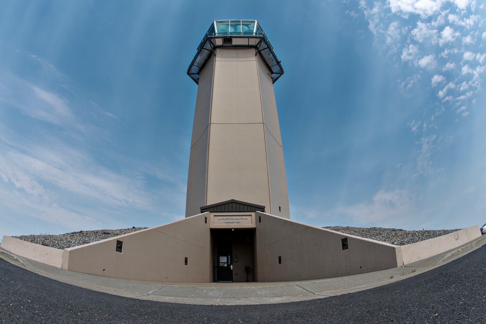 A U.S. Air Force air traffic control tower stands nine stories high at Fairchild Air Force Base, Washington, July 29, 2024. The ATC tower is manned 24/7 to facilitate the safe flow of aircraft to and from the airfield. During their shift, ATC specialists observe weather conditions and assist aircraft during periods or bad weather or aid aircraft dealing with a malfunction. ATC specialists manage the flow of aircraft through all aspects of the flight, ensuring the safety and efficiency of air traffic on the ground and in the air. (U.S. Air Force photo by Senior Airman Morgan St Marks)