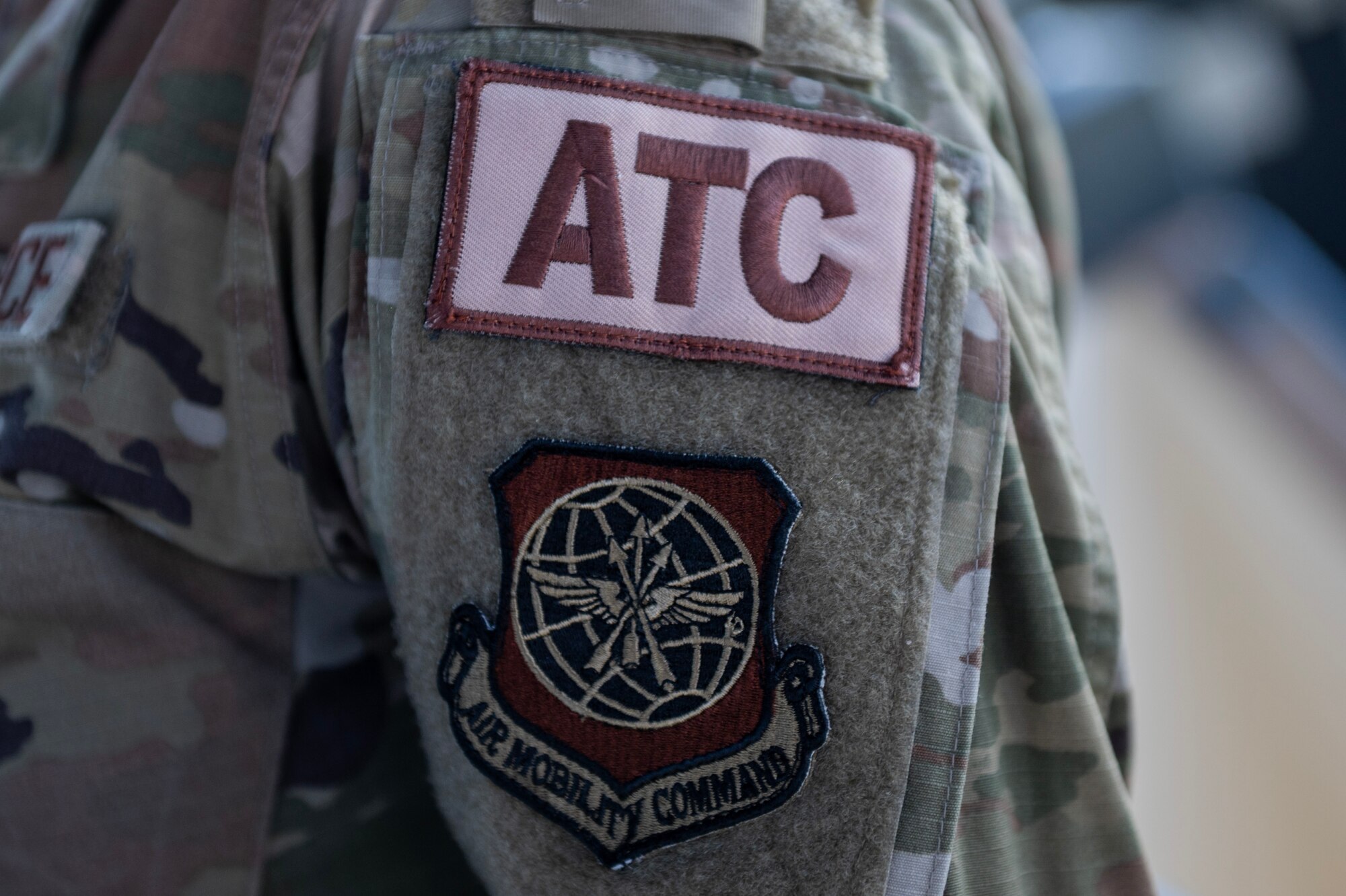 Staff Sgt. Michaela Gundersen, a watch supervisor assigned to the 92nd Operations Support Squadron, wears an air traffic control patch while completing duties in the air traffic control tower at Fairchild Air Force Base, Washington, July 29, 2024. ATC specialists manage the flow of aircraft through all aspects of the flight, ensuring the safety and efficiency of air traffic on the ground and in the air. (U.S. Air Force photo by Senior Airman Morgan St Marks)