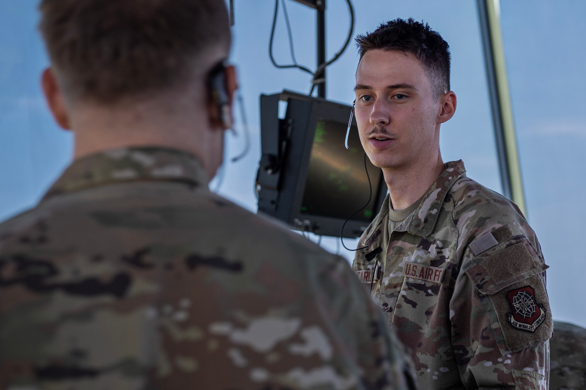 Airman Jacob Carlson, an air traffic control specialist assigned to the 92nd Operations Support Squadron, completes an on-the-job training task from another ATC specialist at Fairchild Air Force Base, Washington, July 29, 2024. Carlson learned flight data, coordination with other facilities, responding to incoming calls, ground control and providing clearance for aircraft to taxi to and from the runway. ATC specialists manage the flow of aircraft through all aspects of the flight, ensuring the safety and efficiency of air traffic on the ground and in the air. (U.S. Air Force photo by Senior Airman Morgan St Marks)