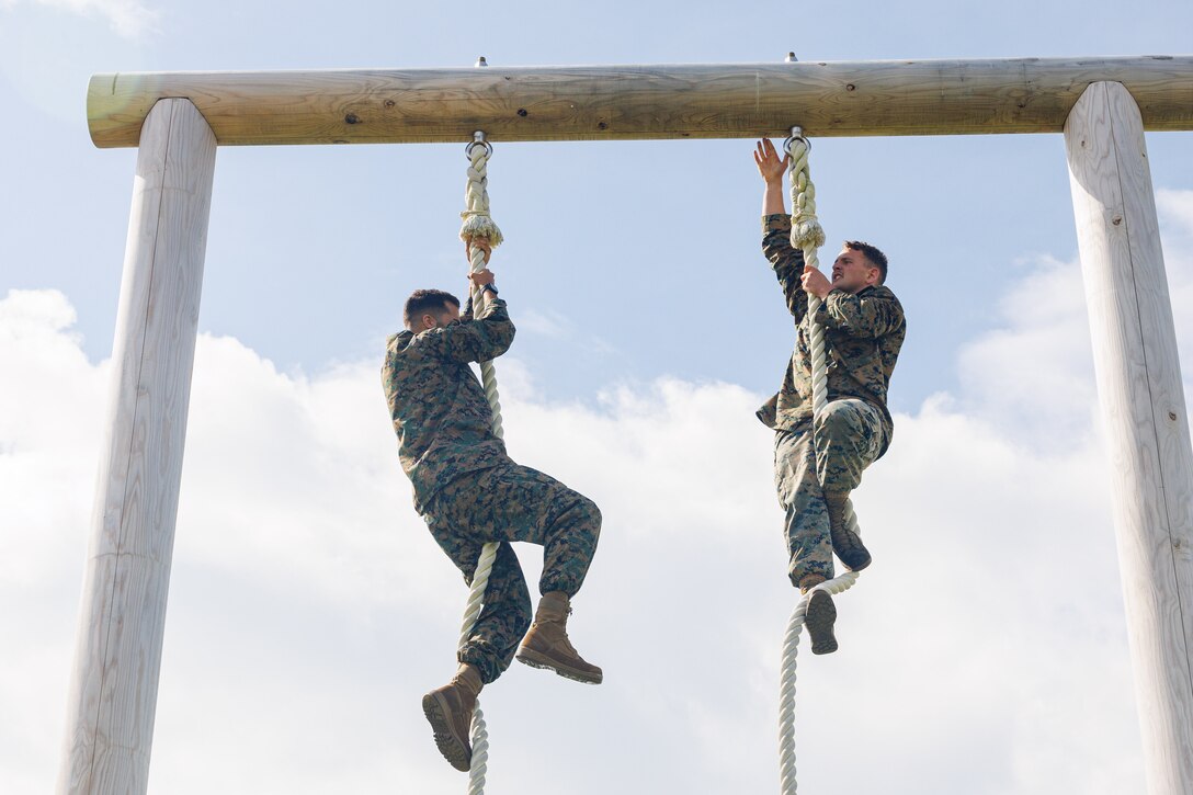 U.S. Marines compete against each other on the final obstacle during the O-Course competition at Marine Corps Air Station Iwakuni, Japan, July 3, 2024. Marines and Sailors competed for the fastest time for a chance to win gift bags filled with tactical gear and to have their name displayed on a leaderboard. (U.S. Marine Corps photo by Lance Cpl. David Getz)