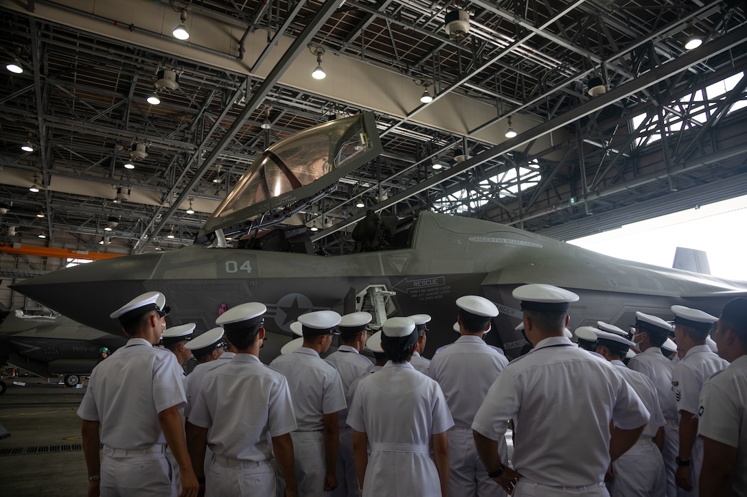 Japan Maritime Self-Defense Force Cadets look at a U.S. Marine Corps F-35B Lightning II assigned to Marine Fighter Attack Squadron (VMFA) 121, Marine Aircraft Group 12, 1st Marine Air Wing, during an installation tour at Marine Corps Air Station Iwakuni, Japan, July 11, 2024. The tour gave JMSDF cadets an overview of the installation's capabilities and gave them an opportunity to see a number of aircraft, such as the F-35B Lightning II, KC-130J Super Hercules, and C-12 Huron. (U.S. Marine Corps photo by Lance Cpl. Colin Thibault)