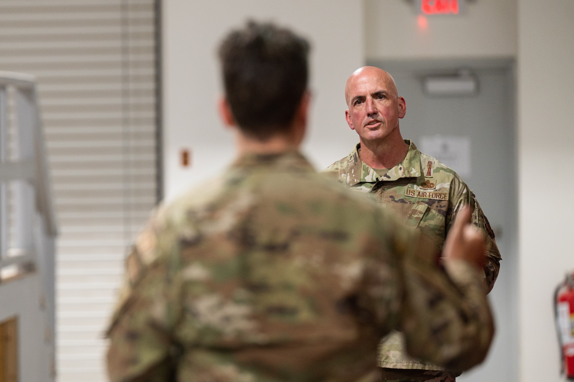 Chief Master Sgt. of the Air Force David Flosi answers questions during an all-call for Airmen assigned to the 332nd Air Expeditionary Wing at an undisclosed location within the U.S. Central Command area of responsibility on July 22, 2024. Flosi addressed the importance of generating readiness, projecting power, developing people and developing capabilities during an era of Great Power Competition. (U.S. Air Force photo)