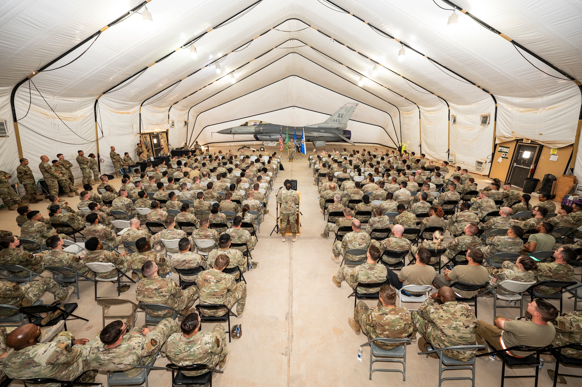 Chief Master Sgt. of the Air Force David Flosi speaks to Airmen from the 378th Air Expeditionary Wing during an all-call at an undisclosed location within the U.S. Central Command area of responsibility, July 23, 2024. During the all-call, he stressed that to achieve seamless readiness for Airmen on day one of their deployment, that it is critical to bring the skills and knowledge they gained over that time back home and to provide a platform to execute that feedback. (U.S. Air Force photo)