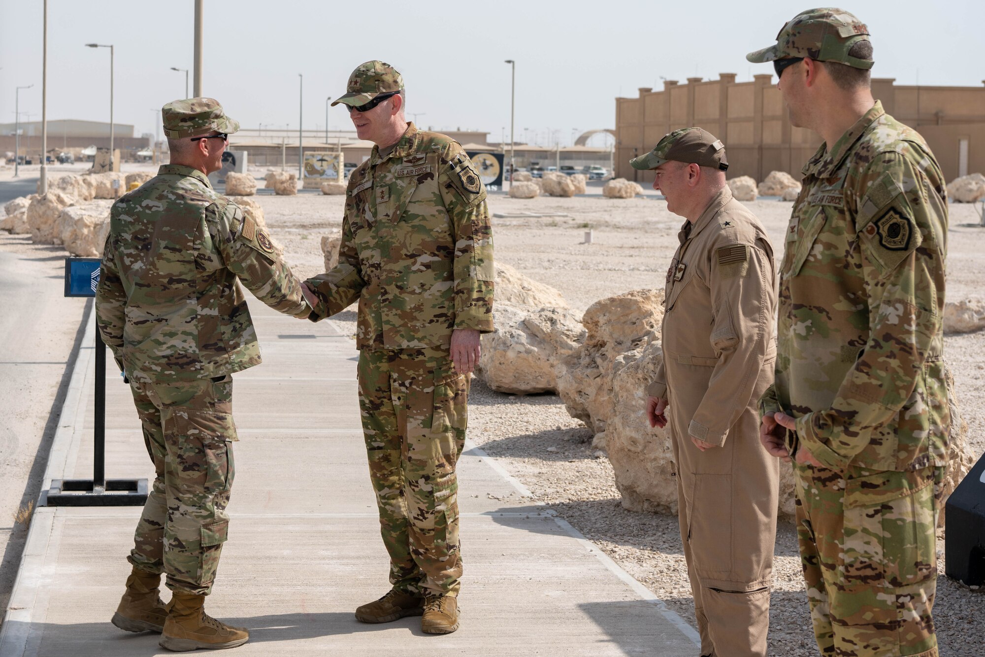 U.S. Air Force Maj. Gen. Curtis Bass, 9th Air Force (Air Forces Central) deputy commander, greets Chief Master Sergeant of the Air Force David Flosi at an undisclosed location within the U.S. Central Command area of responsibility, July 27, 2024. This was Flosi’s first visit as the CMSAF to the CENTCOM AOR. (U.S. Air Force photo)