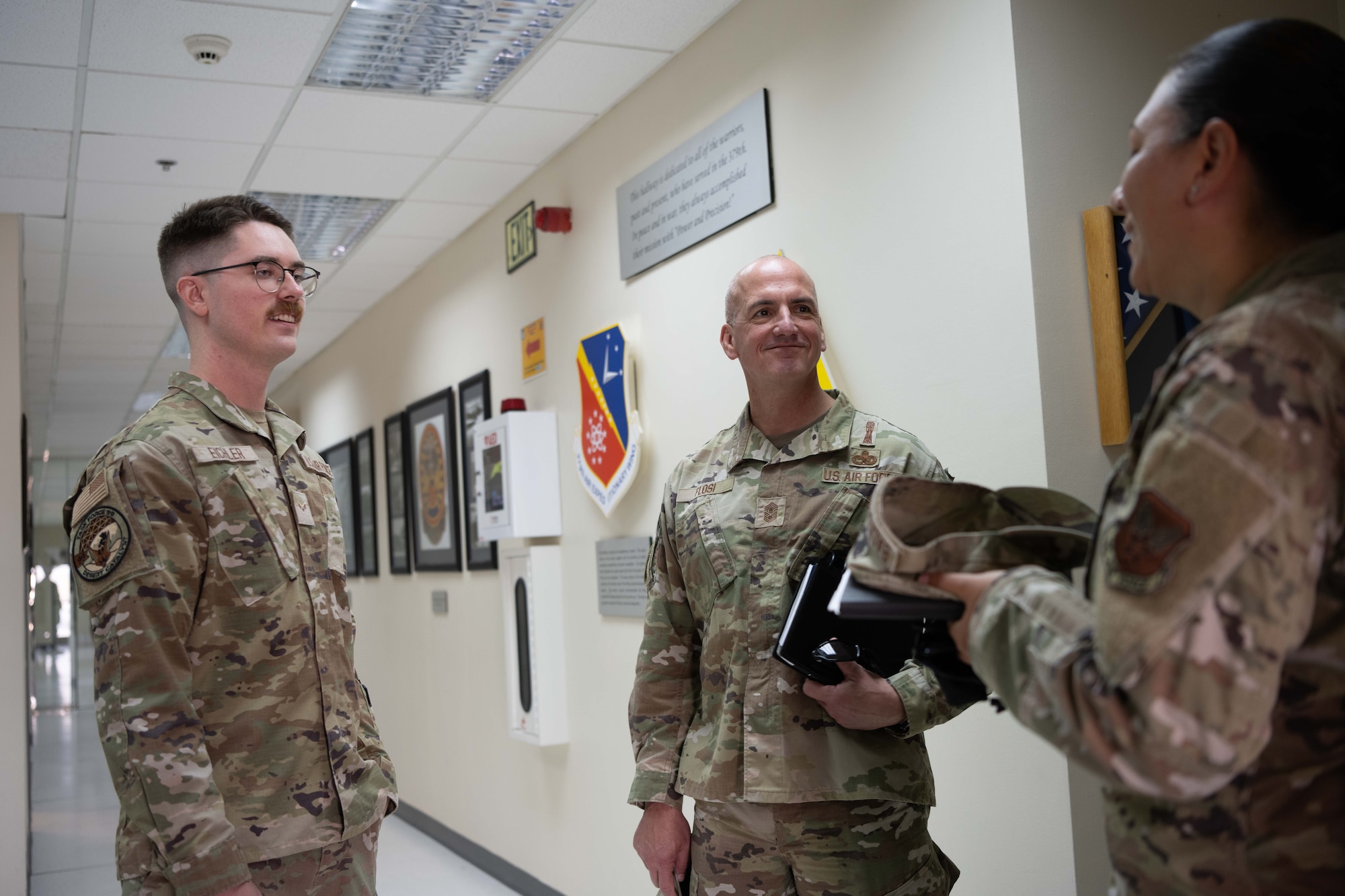 Chief Master Sergeant of the Air Force David Flosi, middle, converses with Airmen of the 379th Air Expeditionary Wing at an undisclosed location within the U.S. Central Command area of responsibility, July 27, 2024. Flosi met with Airmen across Air Forces Central’s main operating locations and five deployed AEWs supporting combat operations to protect allies and deter adversaries. (U.S. Air Force photo)