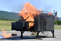 Firefighters with the Fort Indiantown Gap Fire Department train with their new Aircraft Rescue and Fire Fighting trainer across from the Fire Department building at Fort Indiantown Gap, Pennsylvania, July 26, 2024. This was the department's first time using this simulator, which helps them remain ready to save lives of personnel who work at Fort Indiantown Gap. (U.S. Army National Guard photo by Spc. Jessica Barb)