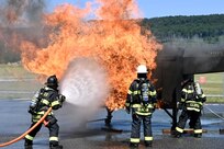 Firefighters with the Fort Indiantown Gap Fire Department train with their new Aircraft Rescue and Fire Fighting trainer across from the Fire Department building at Fort Indiantown Gap, Pennsylvania, July 26, 2024. This was the department's first time using this simulator, which helps them remain ready to save lives of personnel who work at Fort Indiantown Gap. (U.S. Army National Guard photo by Spc. Jessica Barb)