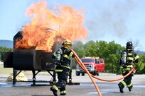 Firefighters with the Fort Indiantown Gap Fire Department train with their new Aircraft Rescue and Fire Fighting trainer across from the Fire Department building at Fort Indiantown Gap, Pennsylvania, July 26, 2024. This was the department's first time using this simulator, which helps them remain ready to save lives of personnel who work at Fort Indiantown Gap. (U.S. Army National Guard photo by Spc. Jessica Barb)