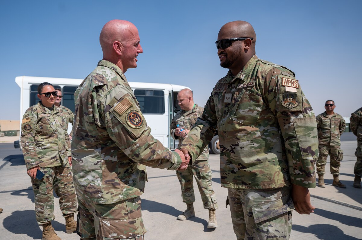 Chief Master Sgt. of the Air Force David Flosi recognizes an Airman assigned to the 332d Air Expeditionary Wing at an undisclosed location within the U.S. Central Command area of responsibility on July 22, 2024. This was Flosi’s first visit to the U.S. Central Command area of responsibility; he met with key leaders to understand changes in mission objectives, recent accomplishments, and current base infrastructure. (U.S. Air Force photo)
