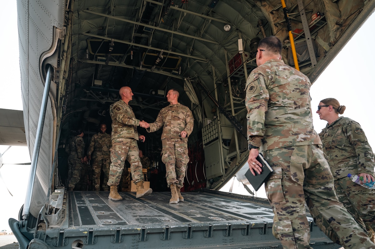 Chief Master Sgt. of the Air Force David Flosi shakes hands with an Airman from the 386th Expeditionary Aeromedical Evacuation Squadron inside of a C-130J Super Hercules at an undisclosed location within the U.S. Central Command area of responsibility, July 25, 2024. Flosi visited the installation to tour dormitories, listen to command briefs, and answer questions from Airmen of all ranks during a base-wide all-call. (U.S. Air Force photo)