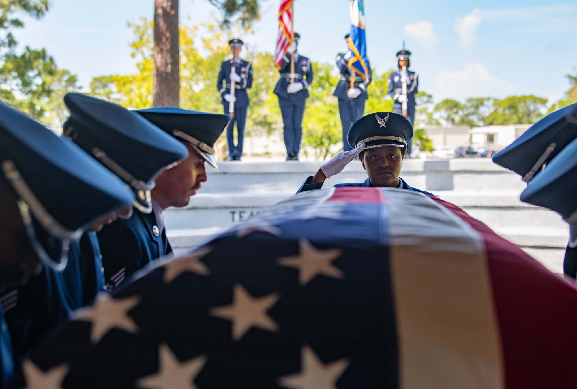 Airman 1st Class Bobbie Mills, ceremonial guardsman, watches as Airmen prepare to fold an American flag during a Team Eglin Honor Guard Graduation ceremony.