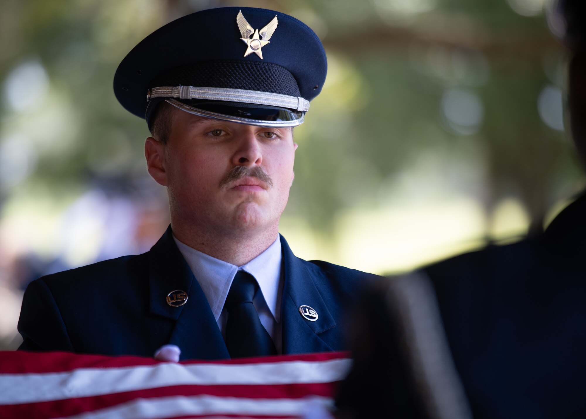 Senior Airman Jacob West, ceremonial guardsman, holds the American flag tightly during a flag folding during the Team Eglin Honor Guard Graduation ceremony.