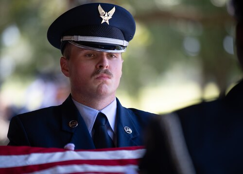 Senior Airman Jacob West, ceremonial guardsman, holds the American flag tightly during a flag folding during the Team Eglin Honor Guard Graduation ceremony.