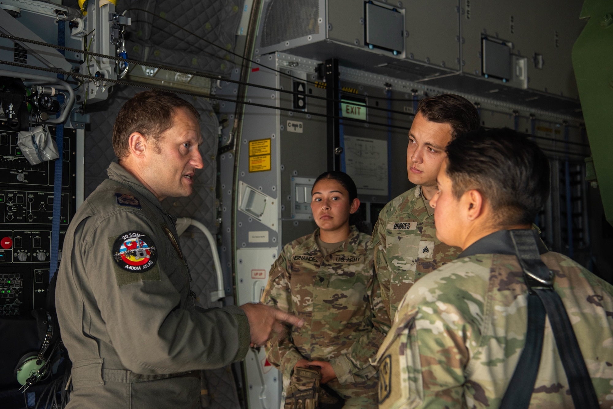 U.S. Air Force and Belgian Air Component members discuss the features of a Belgian A400M Atlas during an M142 High Mobility Rocket System Rapid Insertion training (HIRAIN) at Ramstein Air Base, Germany, July 29, 2024. During the training, a U.S. Army National Guard HIMARS were flown on an A400M Atlas and a U.S. Air Force C-130J Super Hercules to Chievres Air Base, Belgium where crews performed simulated HIRAIN operations.