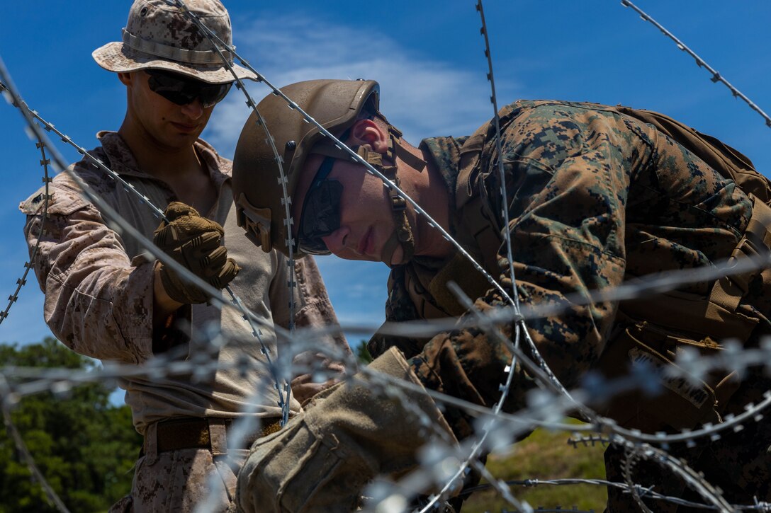 U.S. Naval Reserve Officers Training Corps (NROTC) Midshipmen receive instruction from Marines with 2d Combat Engineer Battalion, 2d Marine Division during the Fleet Marine Force (FMF) Program on Camp Lejeune, North Carolina, July 24, 2024. The FMF is a basic introduction and training event to familiarize NROTC Midshipmen who have committed to the path of becoming a Marine Corps officer, with the primary warfare designators that they will serve in. (U.S. Marine Corps photo by Cpl. Cassidy Shepherd)