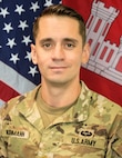 photo of a man in an army uniform in front of the us flag and usace flag