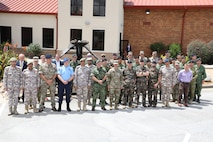 Soldiers posing for a photo in front of the Eisenhower Conference and Catering Center.