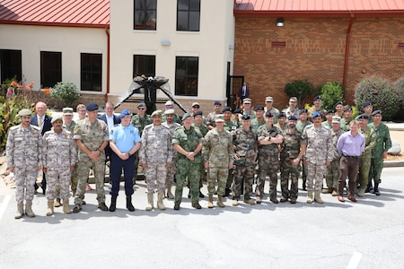 Soldiers posing for a photo in front of the Eisenhower Conference and Catering Center.