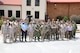 Soldiers posing for a photo in front of the Eisenhower Conference and Catering Center.