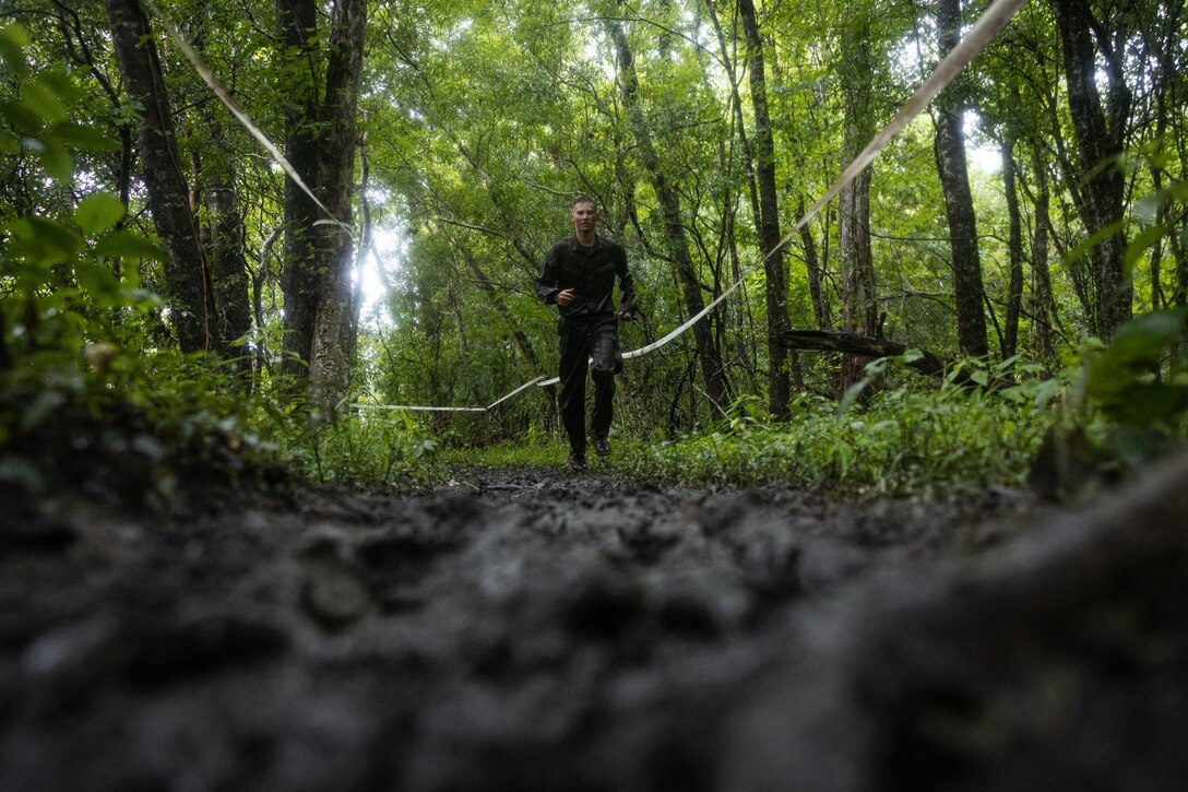 A Naval Reserve Officers Training Corps Midshipman runs through mud while conducting a timed endurance course during Career Orientation and Training for Midshipmen (CORTRAMID) on Camp Lejeune, North Carolina, July 26, 2024. 

CORTRAMID is a month-long opportunity for Midshipmen to step back from university life and experience the operational communities of the US Navy and Marine Corps. (U.S. Marine Corps photo by Cpl. Mary Kohlmann)