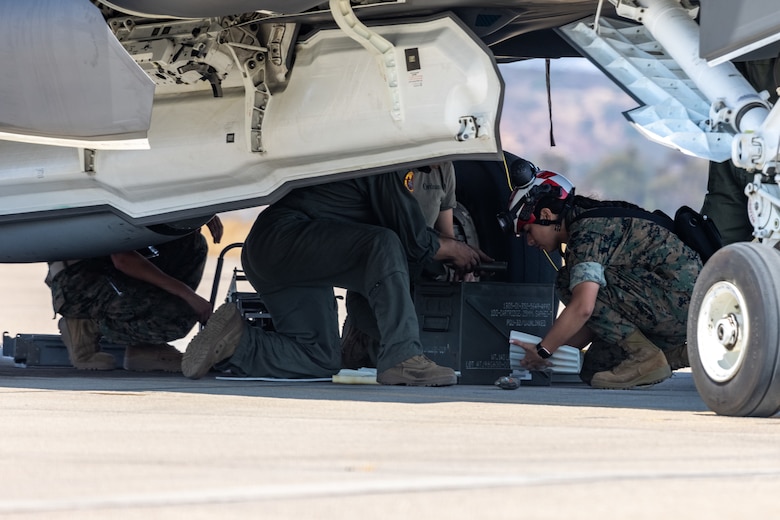 U.S. Marines with Marine Fighter Attack Squadron (VMFA) 311, Marine Aircraft Group 11, 3rd Marine Aircraft Wing, load ordnance onto a U.S. Marine Corps F-35C Lightning II aircraft assigned to VMFA-311, during a live ordnance training event at the Marine Corps Air Station Miramar combat aircraft loading area, California, July 25, 2024. This was the first time VMFA-311 conducted live ordnance operations independently and a milestone for the squadron, which declared initial operational capability on July 31, 2024. Achieving initial operational capability means that VMFA-311 has the operational F-35C aircraft, trained pilots, maintainers, and support equipment to self-sustain its mission essential tasks. (U.S. Marine Corps photo by Lance Cpl. Jennifer Sanchez)