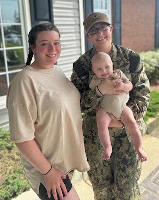 Navy Intelligence Specialist 1st Class Petty Officer Sarah Redsicker, right, a native of Chili, New York and assigned as a Cyber Threat Intelligence (CTI) analyst for Naval Information Warfare Center (NIWC) Atlantic’s Cybersecurity Service Provider (CSSP) team based in Charleston, South Carolina, poses with her son and childhood friend, Rachael Zielke, left, following Redsicker’s reenlistment ceremony April 25 aboard the U.S. Navy Blue Angels’ iconic “Fat Albert” C-130. Zielke traveled from Chili, New York with Redsicker’s father to watch his her fly in “Fat Albert” from the ground. Redsicker reaffirmed her oath to support and defend the Constitution of the United States for another three years in the Navy Reserve.