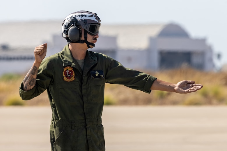 U.S. Marine Corps Cpl. Larry Casas, a fixed-wing aircraft mechanic with Marine Fighter Attack Squadron (VMFA) 311, Marine Aircraft Group 11, 3rd Marine Aircraft Wing, directs a U.S. Marine Corps F-35C Lightning II aircraft during a live ordnance training event at the Marine Corps Air Station Miramar combat aircraft loading area, California, July 25, 2024. This was the first time VMFA-311 conducted live ordnance operations independently and a milestone for the squadron, which declared initial operational capability on July 31, 2024. Achieving initial operational capability means that VMFA-311 has the operational F-35C aircraft, trained pilots, maintainers, and support equipment to self-sustain its mission essential tasks. (U.S. Marine Corps photo by Lance Cpl. Jennifer Sanchez)