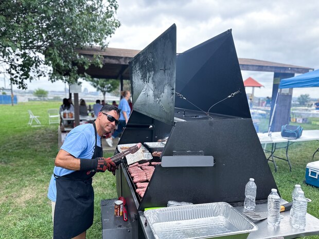 JOINT BASE ANACOSTIA-BOLLING, Washington, D.C. (July 30, 2024) - U.S. Navy Cmdr. Jose 'Manny' Lamberty volunteers at the grilling station during Strategic Systems Programs' (SSP) annual command picnic, Tuesday. This year's event for SSP staff and their families included food, games, a dunk tank, and the car show which featured vehicles--old and new--owned by members of the SSP workforce. The picnic was organized by SSP’s Activity and Recreations Committee (SPARC), an all-volunteer team made up of military and civilians who fundraise and plan MWR events throughout the year. SSP is the Navy command that provides cradle-to-grave lifecycle support for the sea-based leg of the nation’s nuclear triad. (U.S. Navy Photo by Lt. Jennifer Bowman/Released)