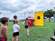 JOINT BASE ANACOSTIA-BOLLING, Washington, D.C. (July 30, 2024) - Kids from the Strategic Systems Programs (SSP) family wait in line to attempt dunking U.S. Navy Capt.  Artie Mueller, director of SSP's Nuclear Weapons Surety Division, during the command's annual  picnic Tuesday. This year's event for SSP staff and their families included food, games, a dunk tank, and the car show which featured vehicles--old and new--owned by members of the SSP workforce. The picnic was organized by SSP’s Activity and Recreations Committee (SPARC), an all-volunteer team made up of military and civilians who fundraise and plan MWR events throughout the year. SSP is the Navy command that provides cradle-to-grave lifecycle support for the sea-based leg of the nation’s nuclear triad. (U.S. Navy Photo by Lt. Jennifer Bowman/Released)