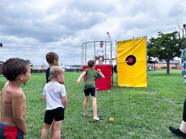 JOINT BASE ANACOSTIA-BOLLING, Washington, D.C. (July 30, 2024) - Kids from the Strategic Systems Programs (SSP) family wait in line to attempt dunking U.S. Navy Capt.  Artie Mueller, director of SSP's Nuclear Weapons Surety Division, during the command's annual  picnic Tuesday. This year's event for SSP staff and their families included food, games, a dunk tank, and the car show which featured vehicles--old and new--owned by members of the SSP workforce. The picnic was organized by SSP’s Activity and Recreations Committee (SPARC), an all-volunteer team made up of military and civilians who fundraise and plan MWR events throughout the year. SSP is the Navy command that provides cradle-to-grave lifecycle support for the sea-based leg of the nation’s nuclear triad. (U.S. Navy Photo by Lt. Jennifer Bowman/Released)