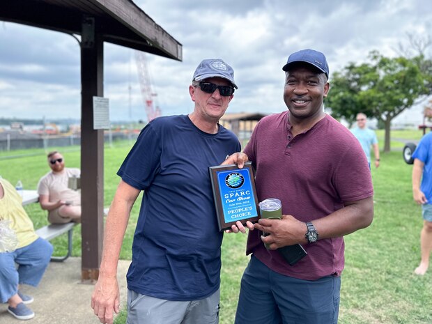 JOINT BASE ANACOSTIA-BOLLING, Washington, D.C. (July 30, 2024) - Strategic Systems Programs (SSP) Director Vice Adm. Johnny Wolfe Jr. (left) awards Capt. Gregory Price (right) 'People's Choice' for his 2020 Acura NSX after votes were tallied  during the command's annual picnic Tuesday. This year's event for SSP staff and their families included food, games, a dunk tank, and the car show which featured vehicles--old and new--owned by members of the SSP workforce. The picnic was organized by SSP’s Activity and Recreations Committee (SPARC), an all-volunteer team made up of military and civilians who fundraise and plan MWR events throughout the year. SSP is the Navy command that provides cradle-to-grave lifecycle support for the sea-based leg of the nation’s nuclear triad. (U.S. Navy Photo by Lt. Jennifer Bowman/Released)