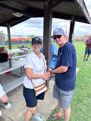 JOINT BASE ANACOSTIA-BOLLING, Washington, D.C. (July 30, 2024) - Strategic Systems Programs (SSP) Director Vice Adm. Johnny Wolfe Jr. (right) awards Ms. Susan Filz (left) 'Best in Show-Truck' for her 1955 Ford F-100 pickup truck after votes were tallied  during the command's annual picnic Tuesday. This year's event for SSP staff and their families included food, games, a dunk tank, and the car show which featured vehicles--old and new--owned by members of the SSP workforce. The picnic was organized by SSP’s Activity and Recreations Committee (SPARC), an all-volunteer team made up of military and civilians who fundraise and plan MWR events throughout the year. SSP is the Navy command that provides cradle-to-grave lifecycle support for the sea-based leg of the nation’s nuclear triad. (U.S. Navy Photo by Lt. Jennifer Bowman/Released)