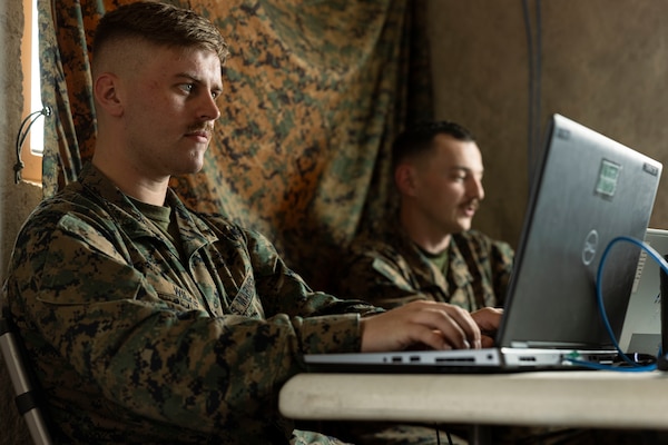 U.S. Marine Corps Lance Cpl. Jackson Wilkie, a defensive cyberspace warfare operator with Delta Company, 3rd Radio Battalion, III Marine Expeditionary Force Information Group, monitors the Marine Corps enterprise network for any digital threats inside an administrative logistics operation center at Marine Corps Base Hawaii on April 8, 2024. The cyberspace Marines were tasked to set up MCEN access to the ALOC and sustain the network integrity during exercise Corvus Dawn 24 battalion operations. CD24 sharpened 3rd RADBN's ability to provide technical information related capabilities to III Marine Expeditionary Force and the joint and multi-national force throughout the Indo-Pacific region. Wilkie is a native of Michigan. (U.S. Marine Corps photo by Cpl. Bridgette Rodriguez)