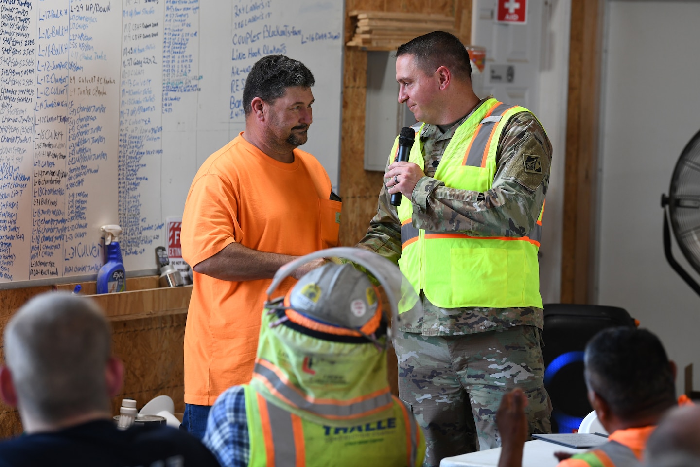 U.S. Army Corps of Engineers Nashville District Commander Lt. Col. Robert Green (right) presents his commander’s coin to Mark Rampage, a signalman and spotter from Thalle Construction, for his commitment to safety practices at a ceremony at Kentucky Lock, in Grand Rivers, Kentucky, July 30, 2024. The ceremony celebrated reaching one-million man-hours of work on the Kentucky Lock without a lost time incident. (USACE Photo by Michael Davis)