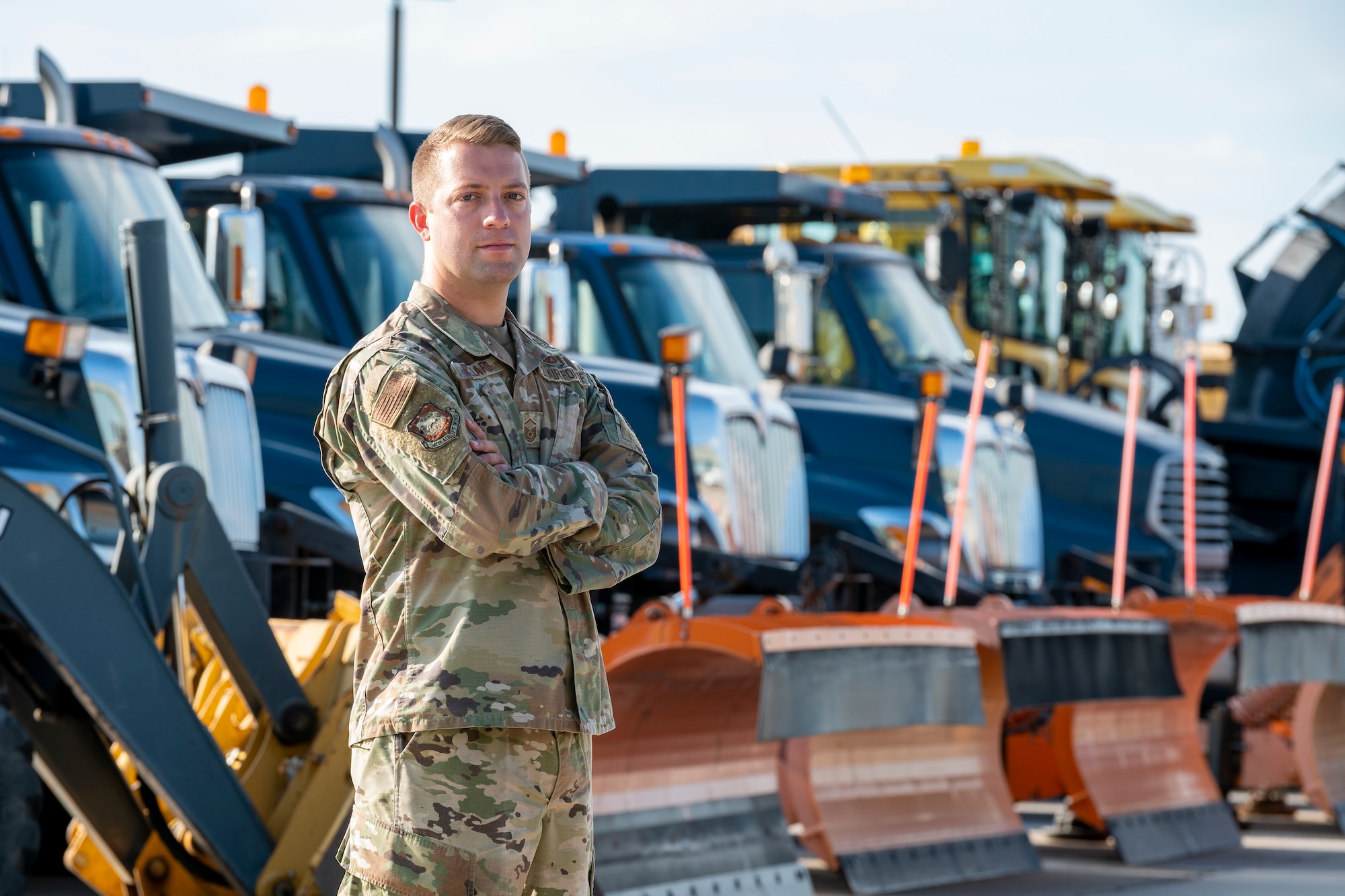 a man stand in front of heavy equipment