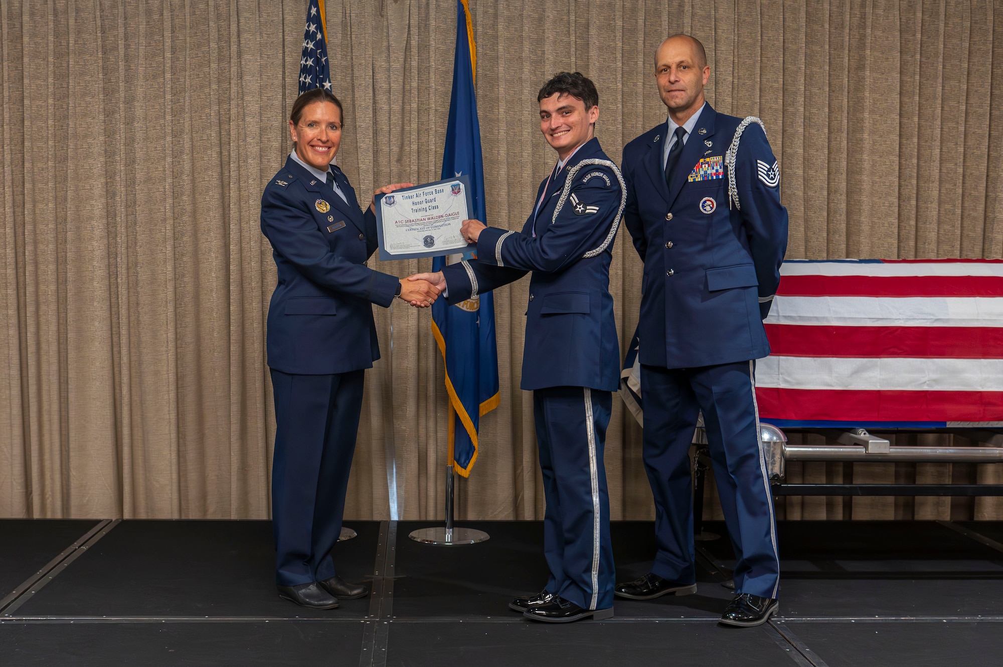 man receives graduation certificate