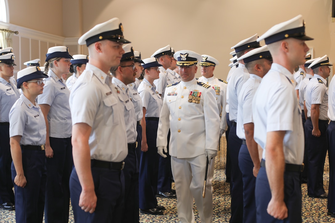 Cmdr. Brian Chapman, foreground, and Cdmr. Aaron Kowalczk, the outgoing and incoming commanding officers of Coast Guard Cutter Reliance (WMEC 615), conduct a personnel inspection together, July 25, during a change-of-command ceremony held at Naval Air Station Pensacola, Florida. The change-of-command ceremony is a time-honored tradition that serves to formally demonstrate the continuity of authority within a command in front of the crew and esteemed guests. (U.S Coast Guard photo by Petty Officer 2nd Class Tyler Goldberg)