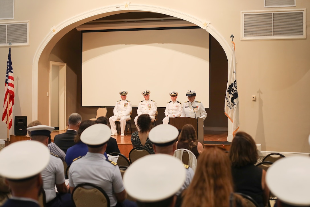 Capt. Kristen Serumgard, chief of operational forces, Coast Guard Atlantic Area, delivers her remarks as presiding official during a change-of-command ceremony for Coast Guard Cutter Reliance (WMEC 615), July 25, at Naval Air Station Pensacola, Florida. The change-of-command ceremony is a time-honored tradition that serves to formally demonstrate the continuity of authority within a command in front of the crew and esteemed guests. (U.S Coast Guard photo by Petty Officer 2nd Class Tyler Goldberg)