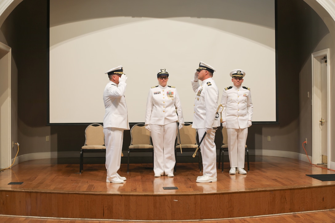 Cmdr. Brian Chapman and Cmdr. Aaron Kowalczk salute one another during a change-of-command ceremony for Coast Guard Cutter Reliance (WMEC 615), July 25, at Naval Air Station Pensacola, Florida. The change-of-command ceremony is a time-honored tradition that serves to formally demonstrate the continuity of authority within a command in front of the crew and esteemed guests. (U.S Coast Guard photo by Petty Officer 2nd Class Tyler Goldberg)