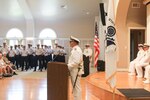 Cmdr. Aaron Kowalczk, incoming commanding officer of Coast Guard Cutter Reliance (WMEC 615), delivers his remarks, July 25, during a change-of-command ceremony at Naval Air Station Pensacola, Florida. The change-of-command ceremony is a time-honored tradition that serves to formally demonstrate the continuity of authority within a command in front of the crew and esteemed guests. (U.S Coast Guard photo by Petty Officer 2nd Class Tyler Goldberg)