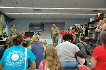 Chief Missile Technician Alex Garrett, Explosives Handling Wharf leading chief petty officer at Strategic Weapons Facility, Atlantic (SWFLANT), explains how ballistic-missile submarines launch TRIDENT D5 missiles underwater to more than thirty children and their caregivers at the Camden County Public Library in Kingsland, Georgia, June 28, 2024. A team of volunteers from SWFLANT, Lockheed Martin and General Dynamics hosted the event during the Science, Technology, Engineering, and Mathematics (STEM) day of the library’s summer learning series. (U.S. Navy photo by Ashley Berumen)