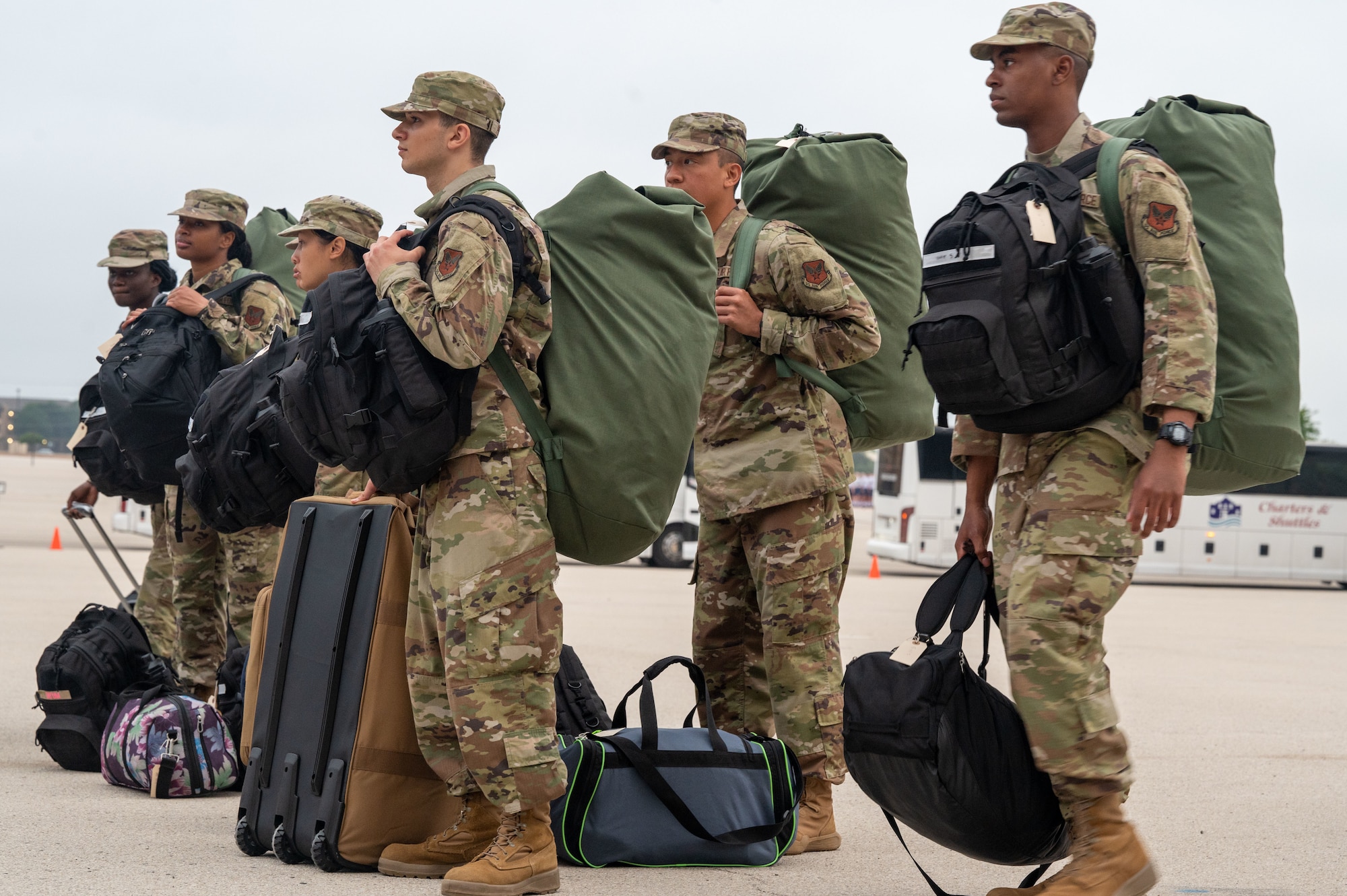On April 19, 2024, Airmen stand with their belongings in the Pfingston Reception Center Airman’s Arena to board buses that will send them to their different technical training locations across the country. Each Friday morning, Airmen who graduated from Basic Military Training the day before, arrive at the Pfingston Reception Center to depart to their technical training schools where they will learn how to thrive in their specific jobs.  (U.S. Air Force by Ava Leone)