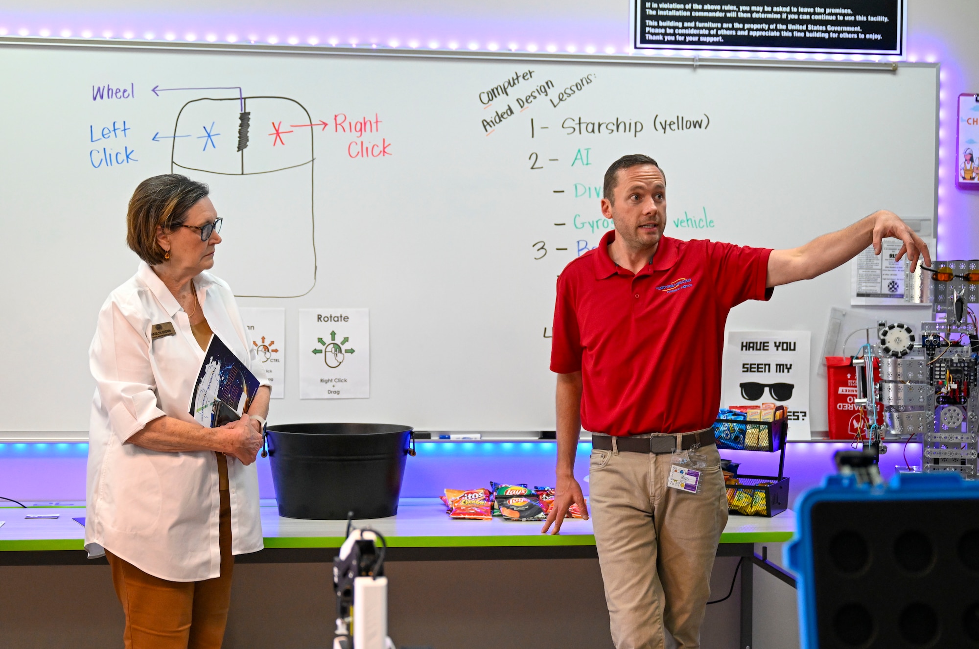 A man stands in a classroom and speaks.
