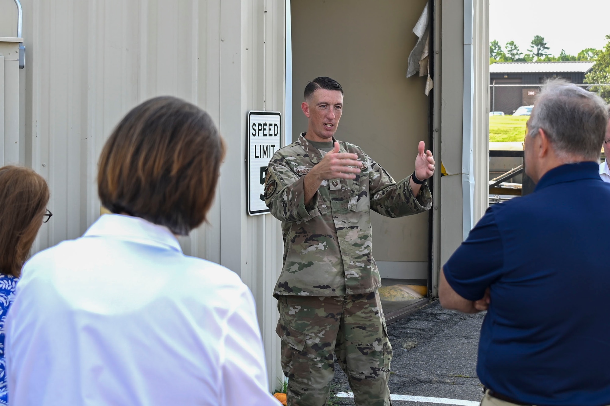 A man speaks to a group of people.