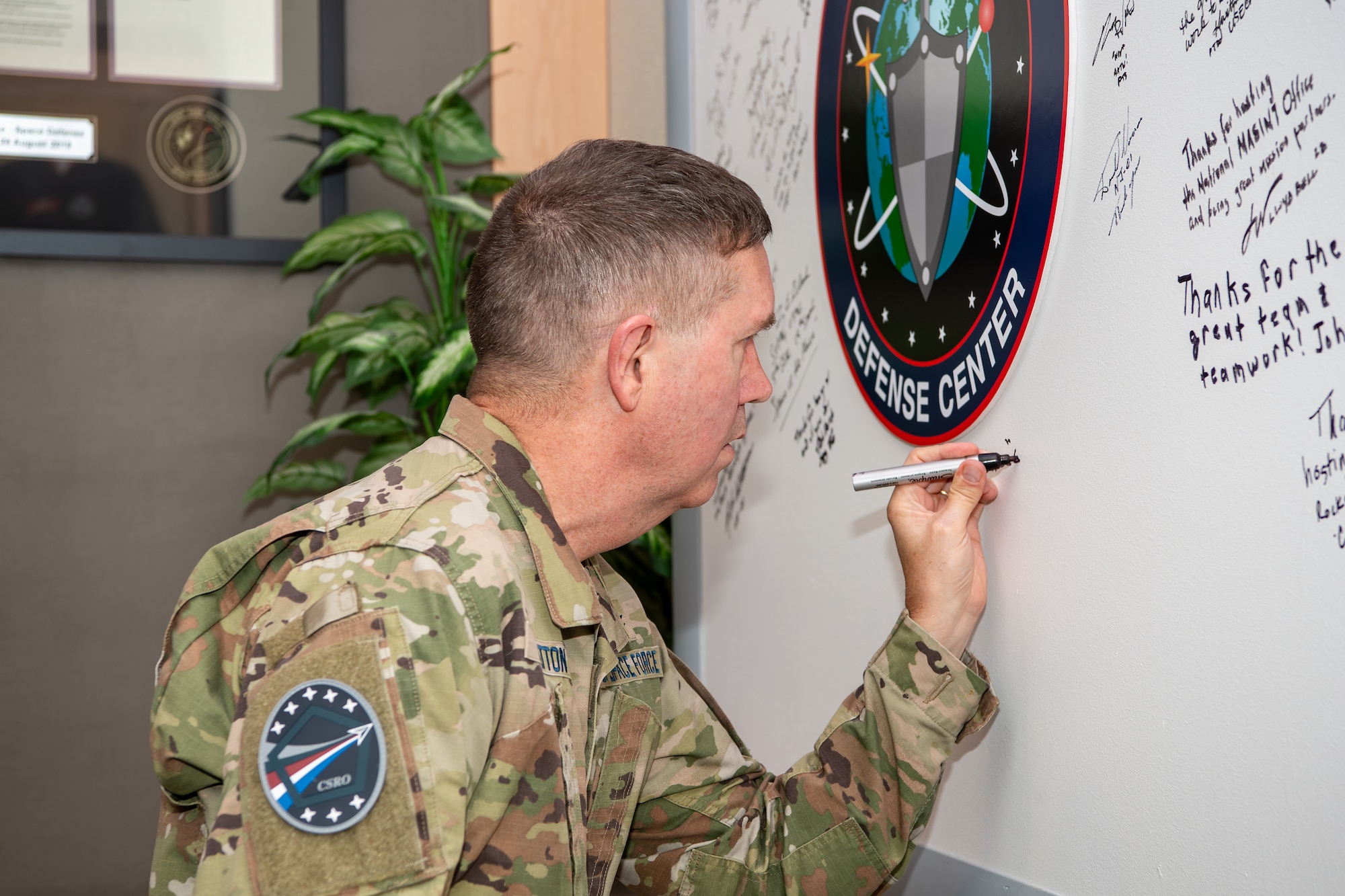 Man in uniform signs board