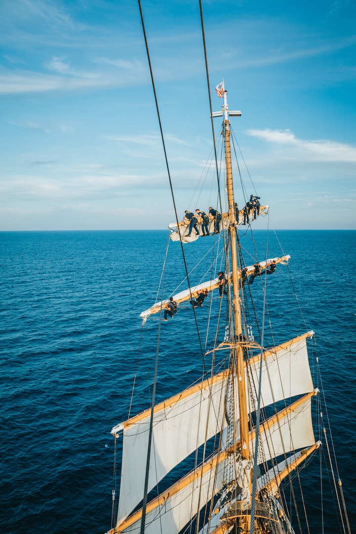 Crewmembers and Academy cadets aboard the U.S. Coast Guard Cutter Eagle (WIX 327) set sail stations in the North Atlantic, July 22, 2024. Cadets train alongside Eagle crewmembers, preparing for life underway as future Coast Guard officers. (U.S. Coast Guard photo by Petty Officer 2nd Class Trever Hammack)