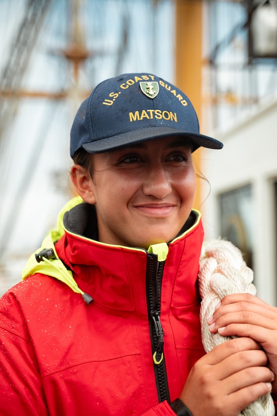 U.S. Coast Guard Cadet 4th Class Amelia Matson smiles aboard Coast Guard Cutter Eagle (WIX 327) while departing Portsmouth, New Hampshire, July 29, 2024. Eagle serves as a classroom-at-sea for Academy Cadets. (U.S. Coast Guard photograph by Petty Officer 3rd Class Matt Thieme)