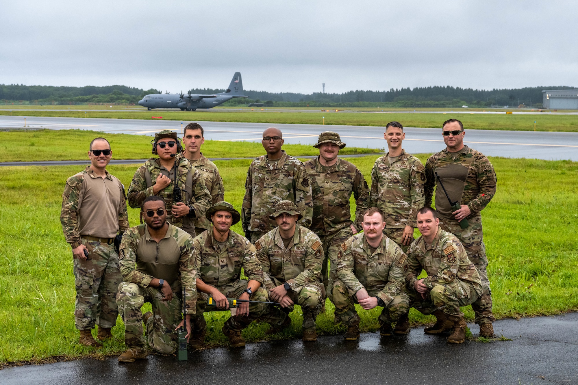 Landing Zone Safety Officer (LZSO) course instructors and participants pose for a group photo on the flightline at Misawa Air Base, Japan, July 26, 2024.